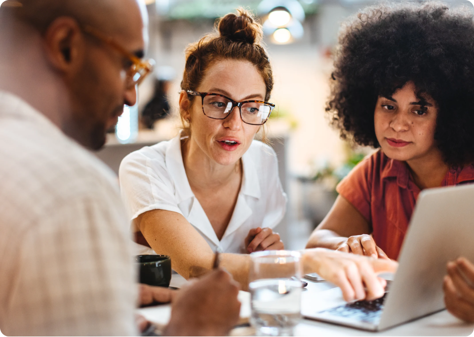 People at a table looking at a laptop