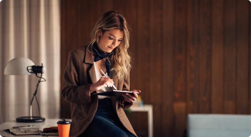 Person writing on a tablet