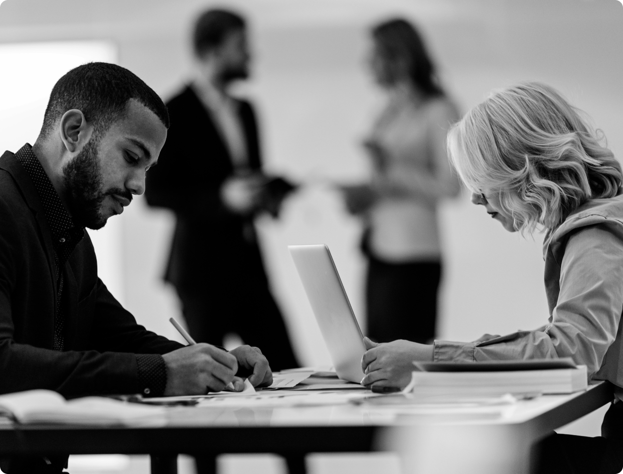 Two people working with a laptop