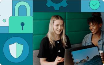 Two people looking at a laptop and smiling