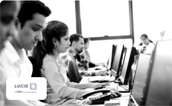 Colleagues work at computers beside the Lucid logo