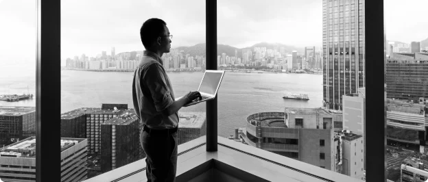 Person on laptop looking out of a window