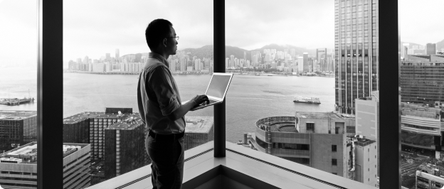 Person on laptop looking out of a window