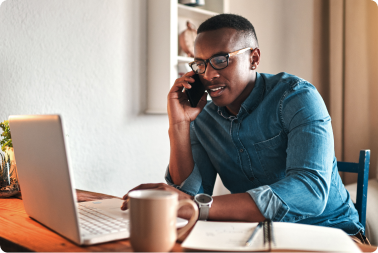 Man on phone on computer