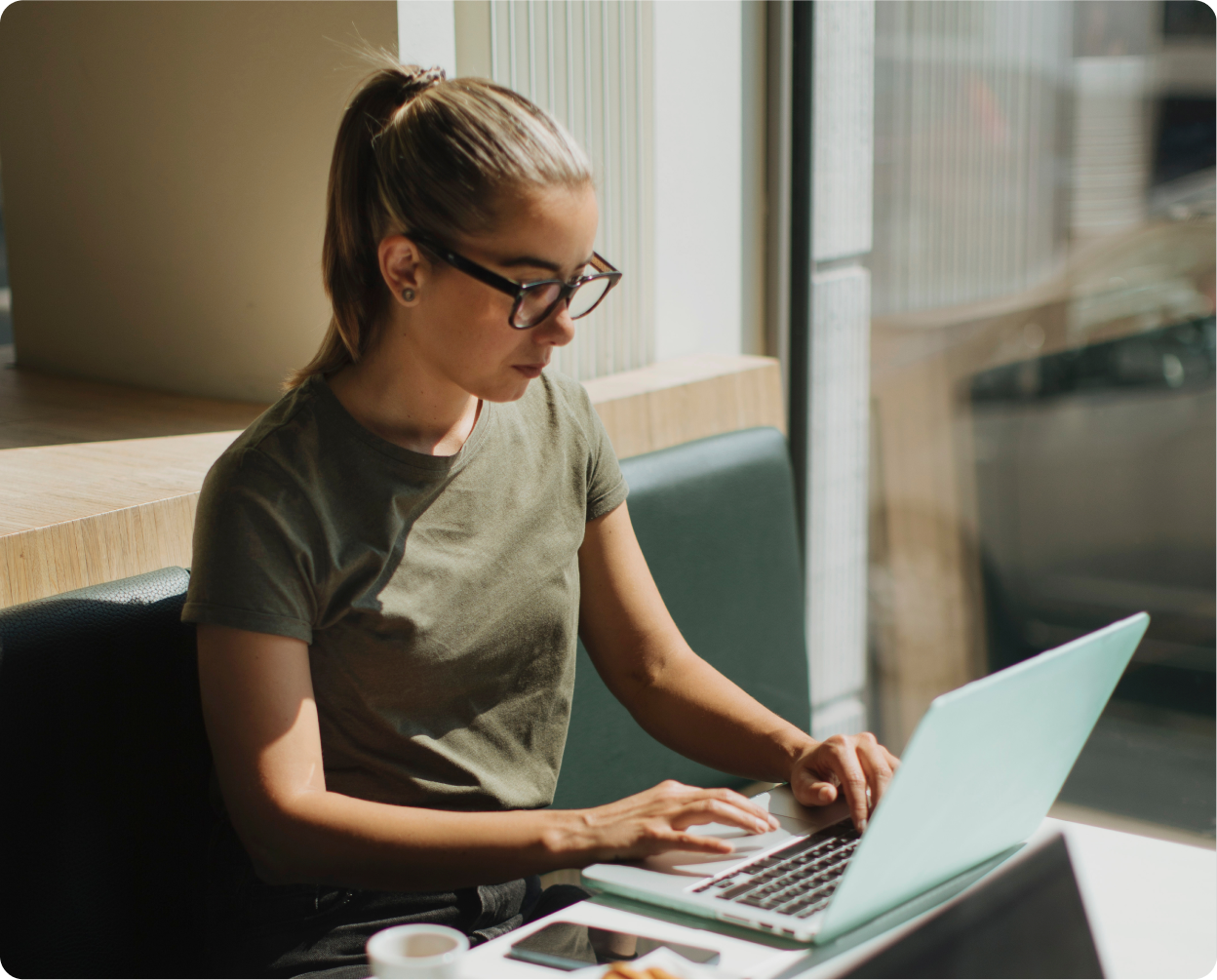 Person with glasses looking at laptop
