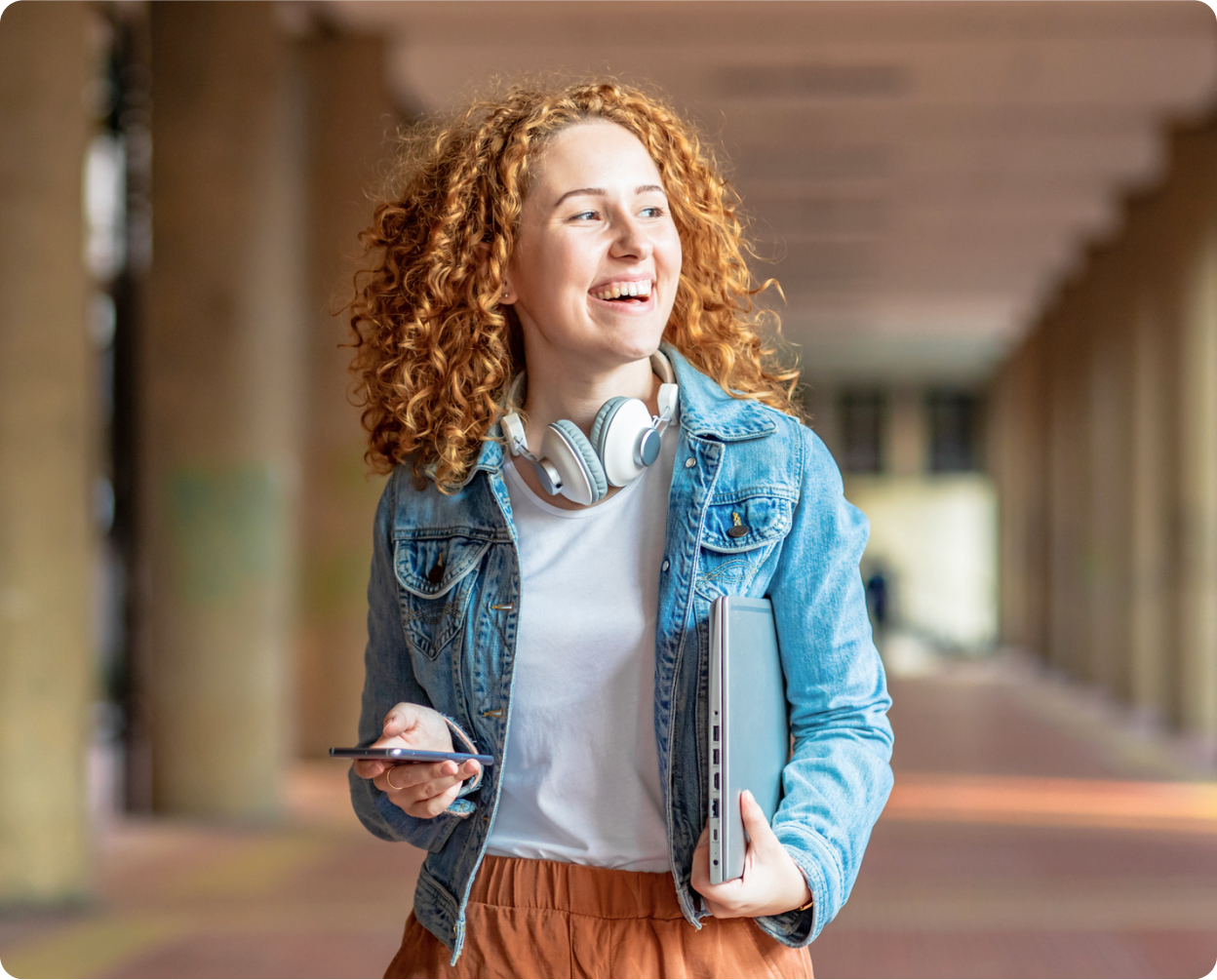 Person walking down a hall smiling