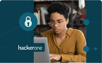 Woman typing on a laptop with the HackerOne logo