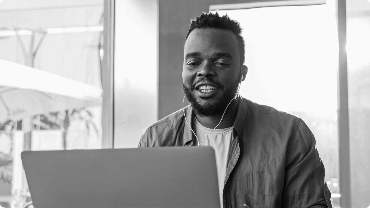 Person with headphones looking at laptop