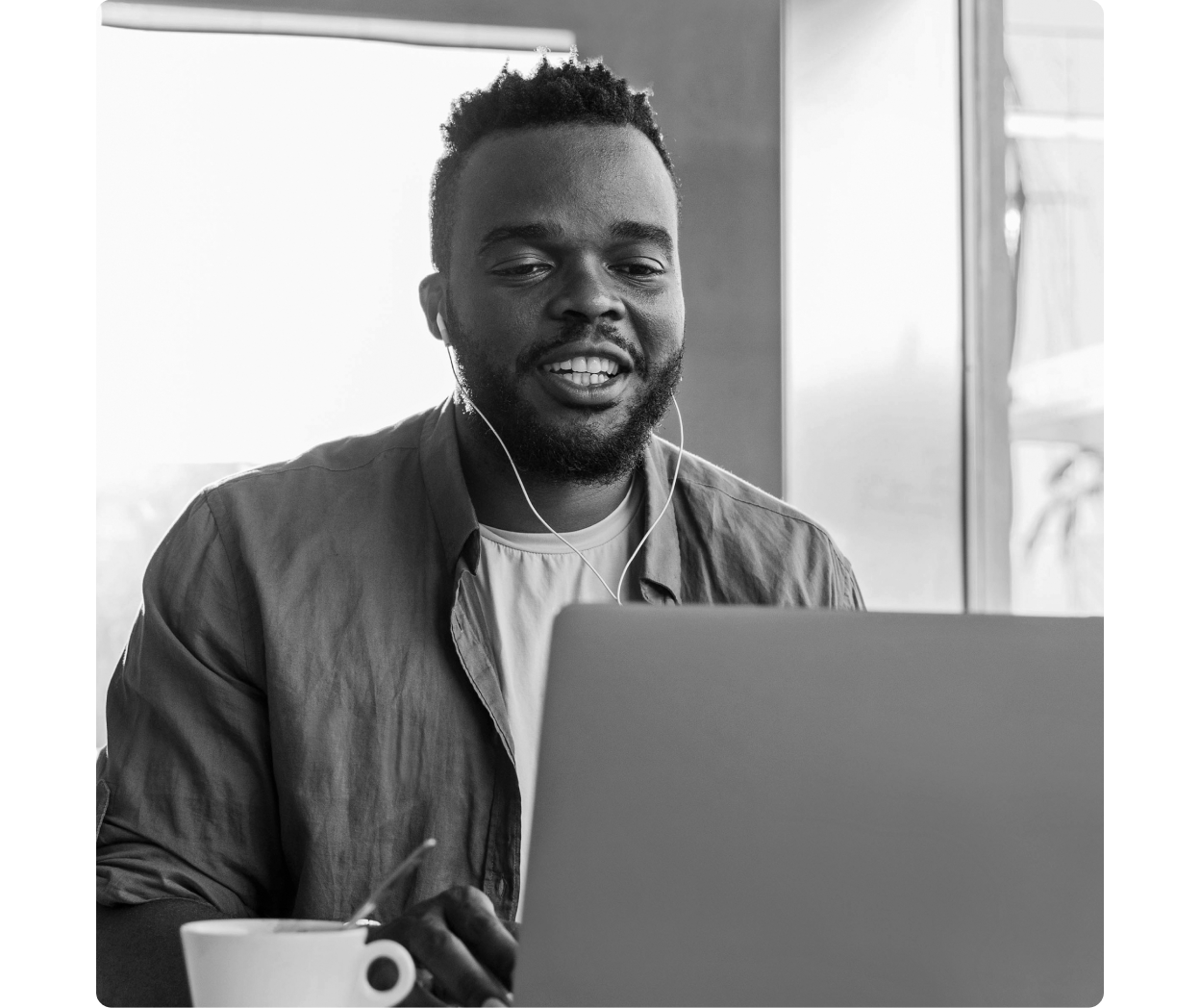 A person talks while working on a laptop 