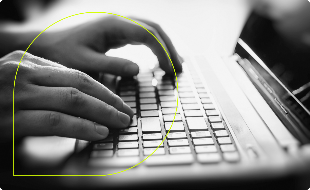 Hands typing on a keyboard with the Grammarly logo