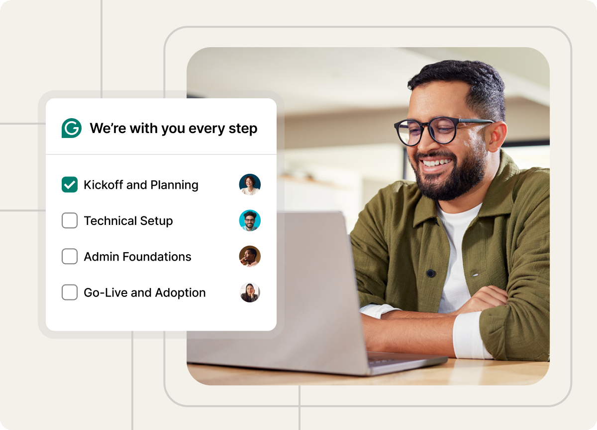 Person wearing glasses smiling at a laptop