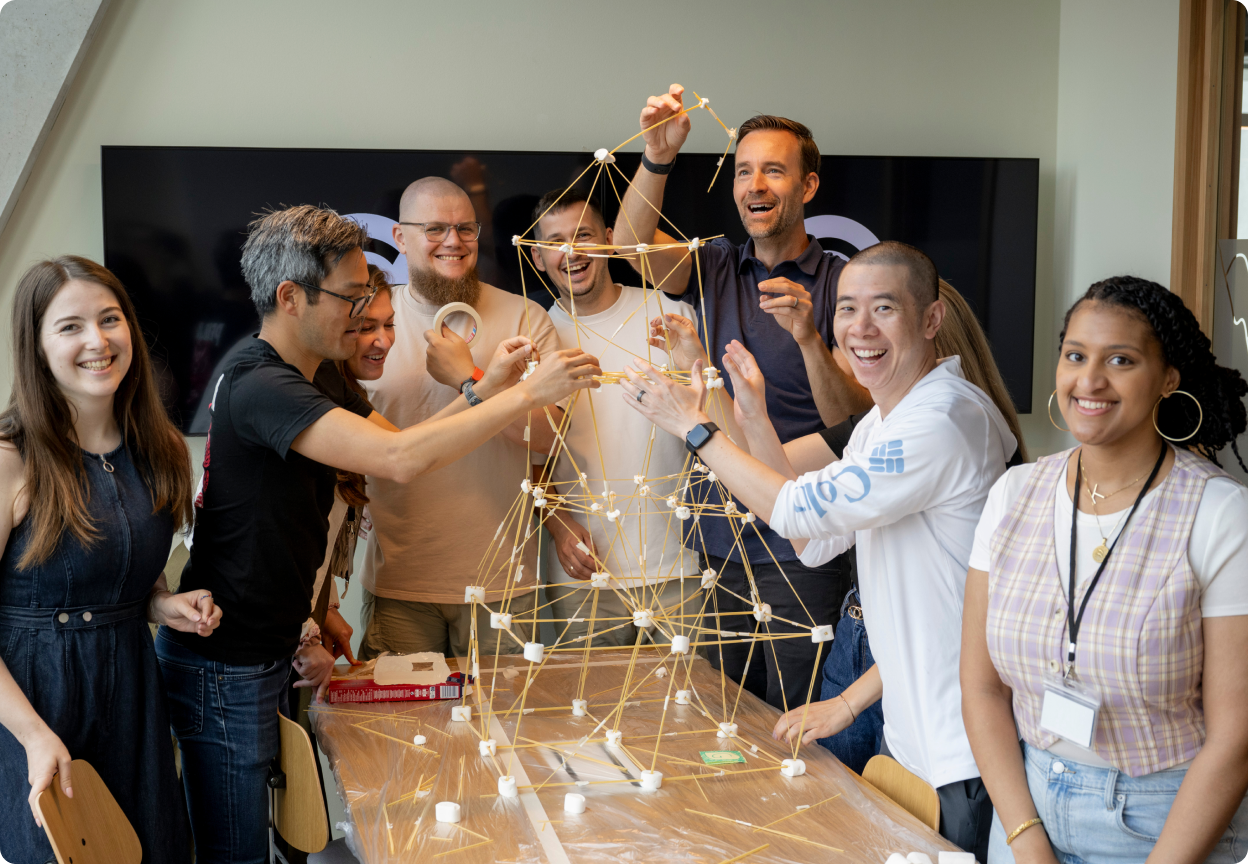 Grammarly employees building a tower together